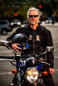 Portrait of strong man on Motorcycle in Newton, Massachusetts.